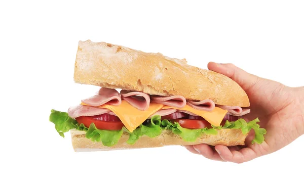 Hand holds french baguette sandwich. — Stock Photo, Image