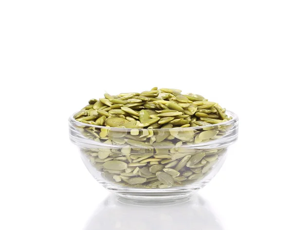 Glass bowl full with pumpkin seeds. — Stock Photo, Image