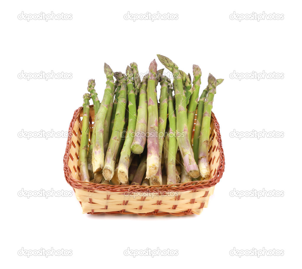 Wicker basket full with asparagus.