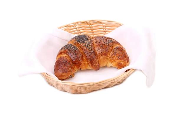 Croissant with poppy on wicker basket. — Stock Photo, Image