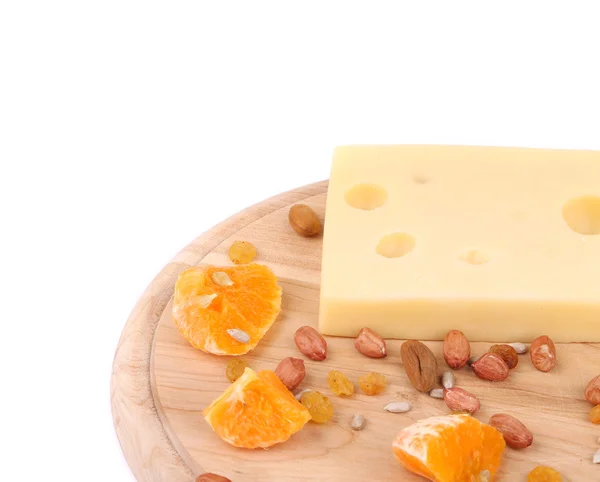 Cheese on board with nuts and orange. — Stock Photo, Image