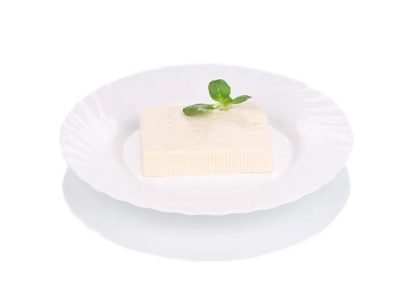 Tasty feta cheese on plate with herb. — Stock Photo, Image