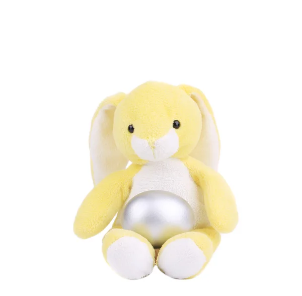 Yellow easter toy rabbit with silver egg. — Stock Photo, Image