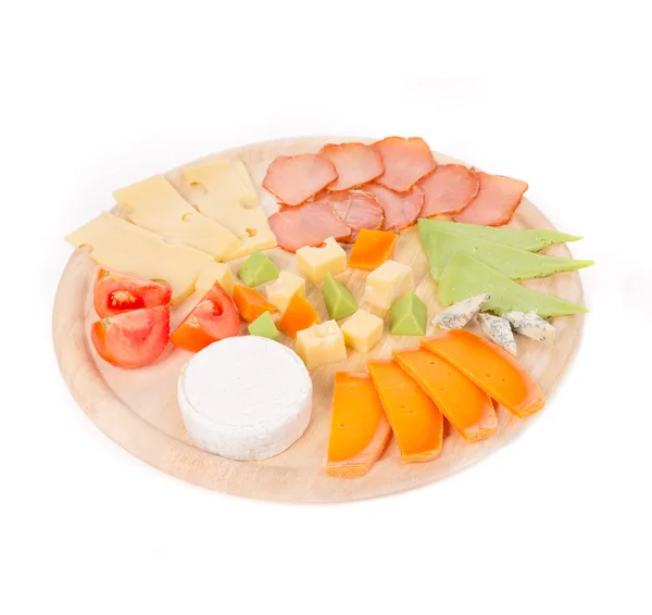 Meat and cheese on wooden platter. — Stock Photo, Image