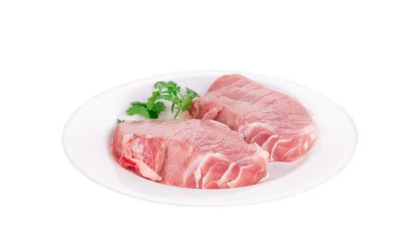 Rohe Schweinesteaks auf Teller. — Stockfoto