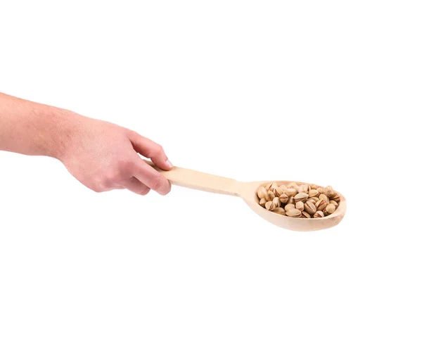 Hand holding spoon with pistachios. — Stock Photo, Image