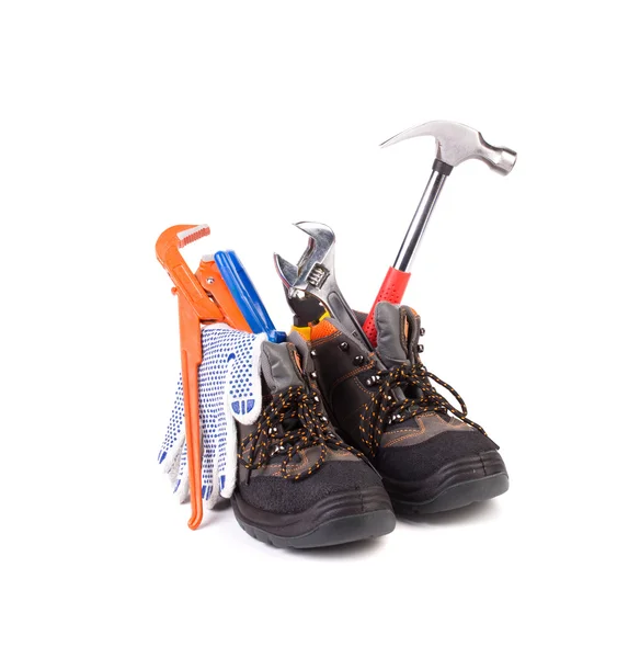 Pracovní nástroje v botách. — Stock fotografie