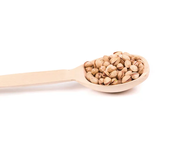 Wooden spoon with pistachios. — Stock Photo, Image