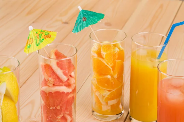 Tasty various juices on wood table. — Stock Photo, Image