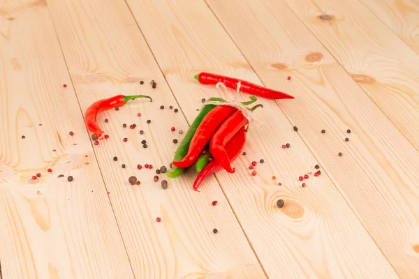 Bunch of fresh cayenne red pepper on wood table — Stock Photo, Image