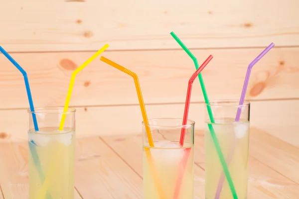 Glasses of lemonade on the wooden background — Stock Photo, Image