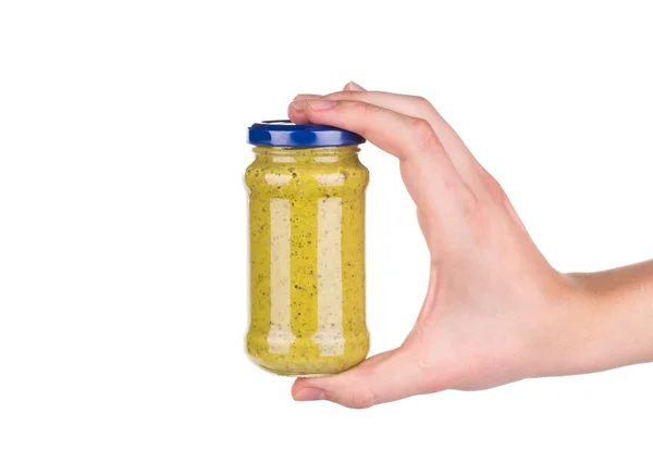 Mustard jar sauce in hand — Stock Photo, Image