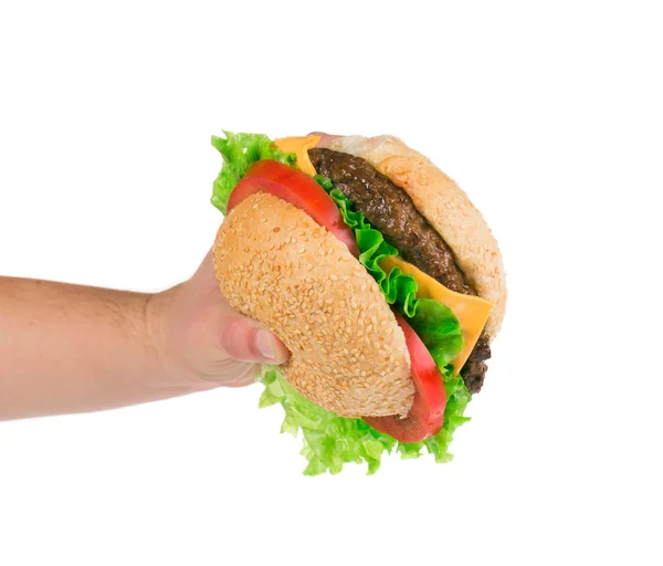 Mano sosteniendo hamburguesa grande sobre fondo blanco —  Fotos de Stock