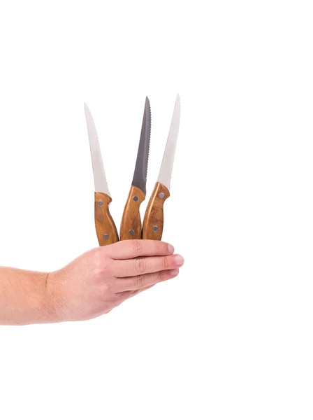 Mano sostiene tres cuchillos de cocina . —  Fotos de Stock