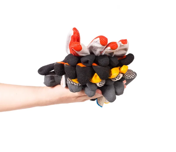 Verschiedene Handschuhe im Stapel auf einer Hand. — Stockfoto