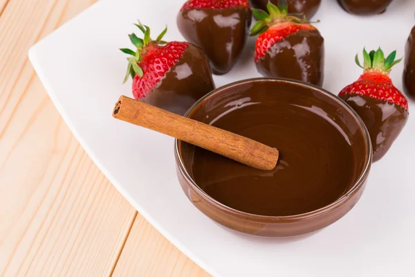 Strawberries in chocolate with cinnamon — Stock Photo, Image