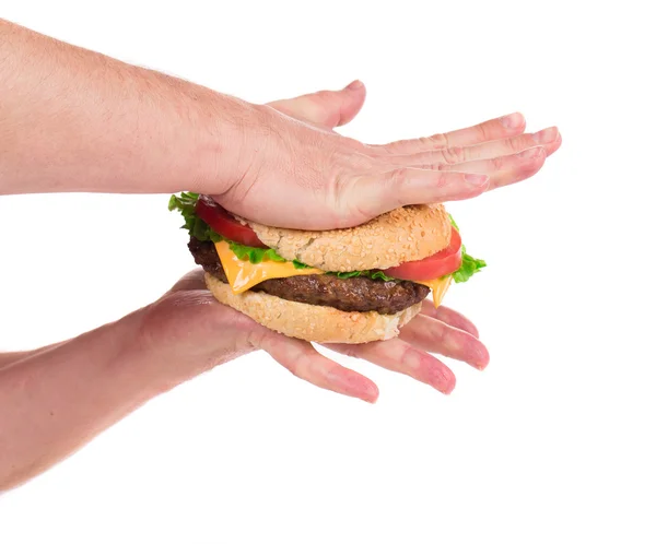 Hands press juicy hamburger. — Stock Photo, Image