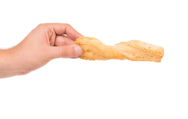 Hand holds bread with sesame. — Stock Photo, Image