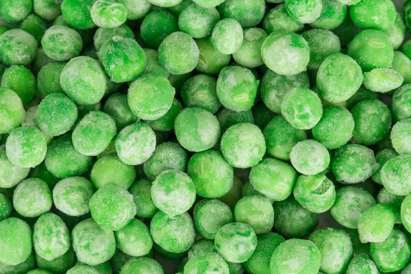 Primer plano de guisantes verdes congelados . —  Fotos de Stock