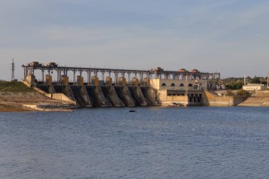 The hydroelectric power plants on the river. The evening on the river.