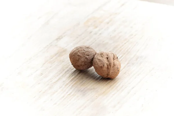 Two Whole Delicious Brown Walnuts Light Wood Vignetting Effect Applied — Stockfoto