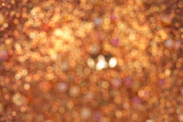 Blurred texture is made of crushed fine golden glass and beads. Fragments of this image can be used as textures. Close-up.