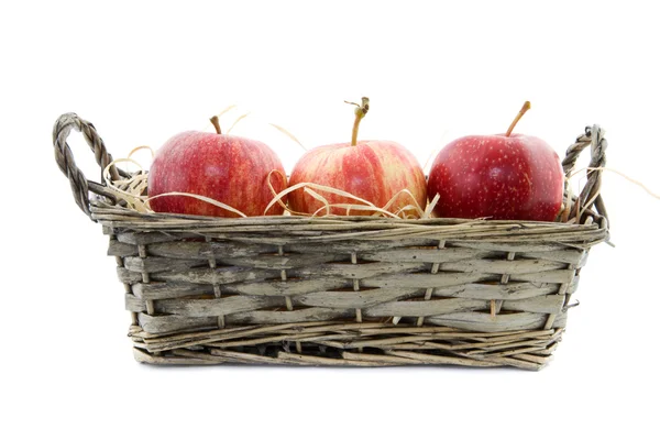 Three apples in a reed basket — Stock Photo, Image