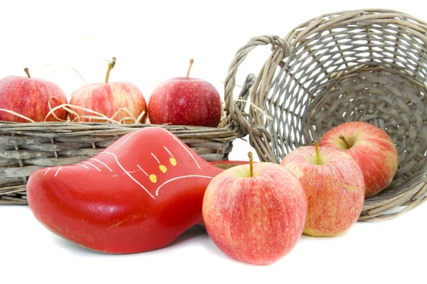 Red apples and wooden shoe — Stock Photo, Image