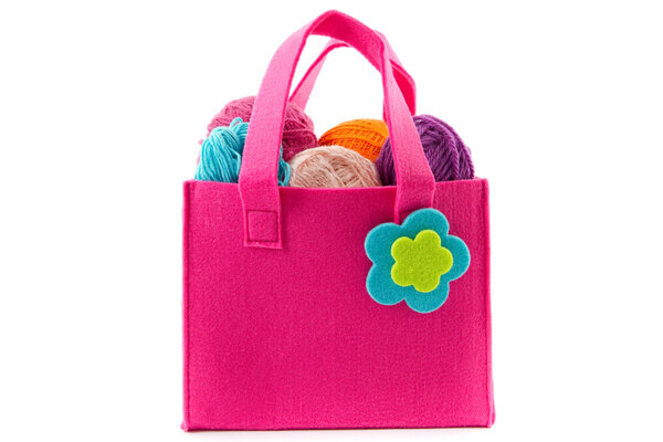 balls of yarn in a felt handbag