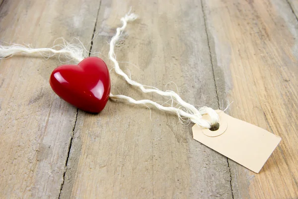 Plastic heart and label tag — Stock Photo, Image