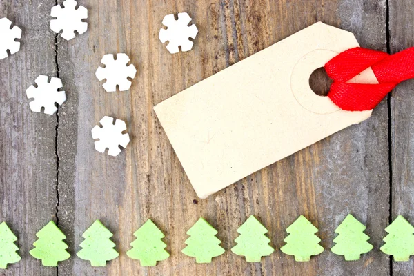 Cardboard label tag with snow flakes and christmas tree sweets — Stock Photo, Image