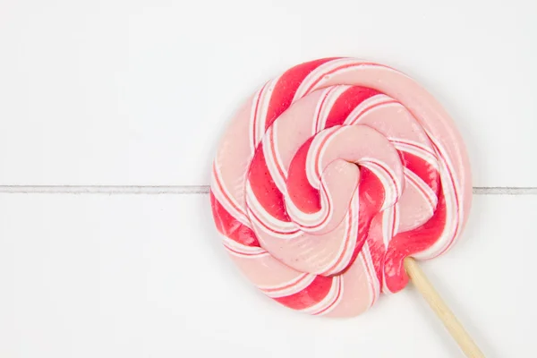 Lollipop on a wooden surface — Stock Photo, Image