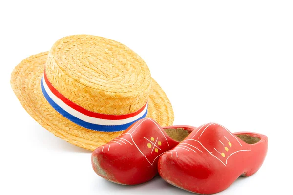 Orange reed hat and red wooden shoes — Stock Photo, Image