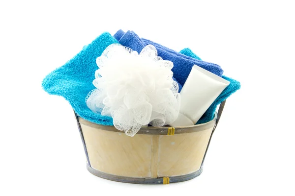 Small tub filled with bath puff, bath foam and towels — Stock Photo, Image