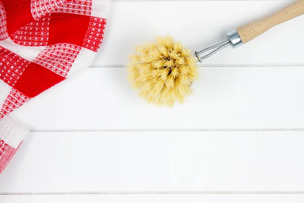 Top-view of red checkered tea towel and dishwashing brush — Stock Photo, Image