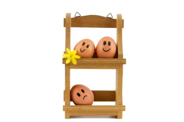 Wooden egg rack with three eggs with facial expressions clipart