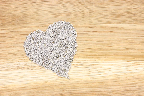 Heart symbol made of white chia seeds — Stock Photo, Image