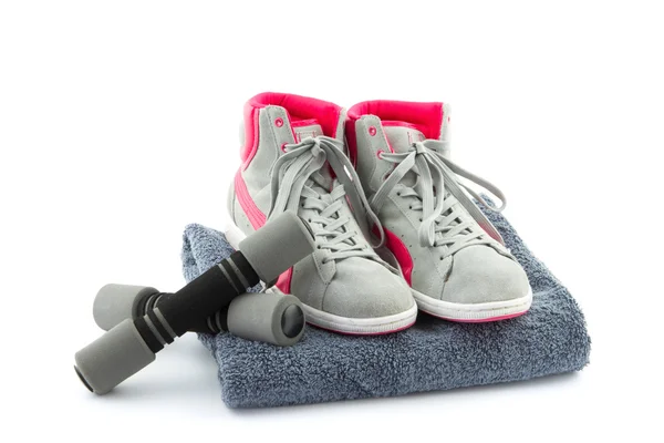 Sneakers with dumbbells and towel — Stock Photo, Image