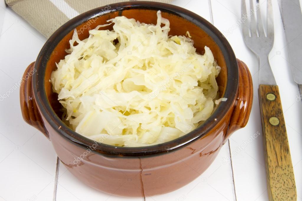 bowl filled with raw sauerkraut and fork and knife