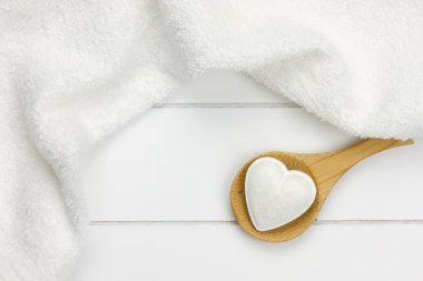 Small bath bomb in heart shape on wooden spoon clipart