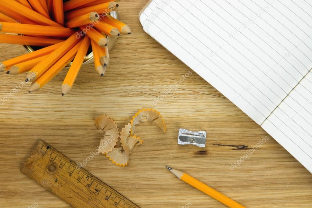Top-view of pencils, lined paper, ruler and pencil sharpener Stock Photo by ©EllenMol 42333725