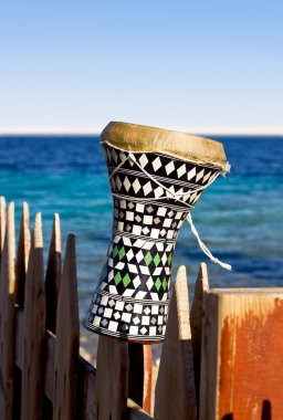 Ethnic drum with a sea background. darbuka. traditional Egyptian drum clipart