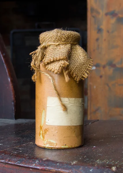 Tagged bottle ceramic bottle close sackcloth — Stock Photo, Image