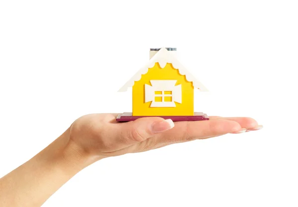 Female hand holding a yellow house — Stock Photo, Image