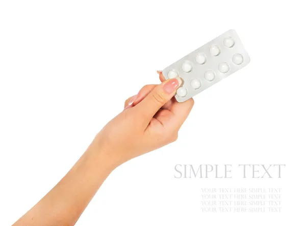 Hand met medische drugs - volledige zilveren bijsluiter van witte pillen — Stockfoto