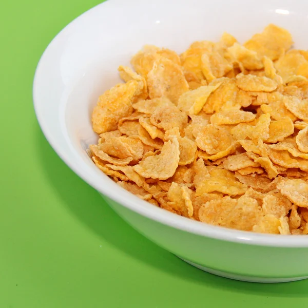 Desayuno saludable-Cornflake sobre un fondo verde — Foto de Stock