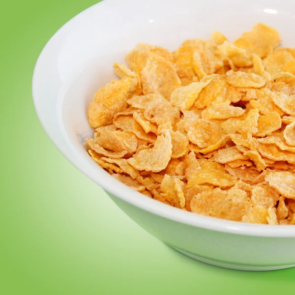 Egészséges reggeli-cornflake egy zöld háttér — Stock Fotó