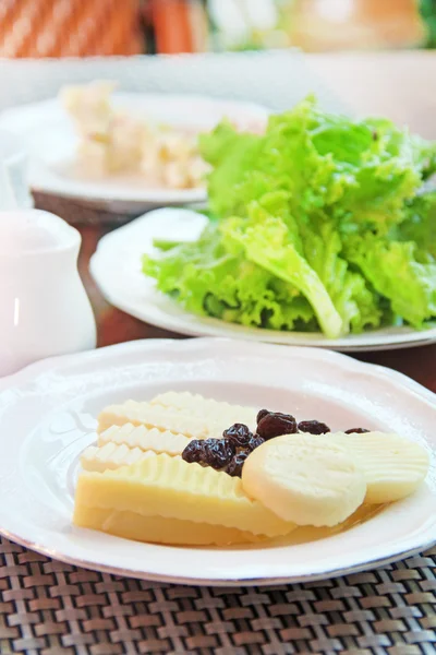 Arrangement of dairy products and lettuce on a table — Stock Photo, Image