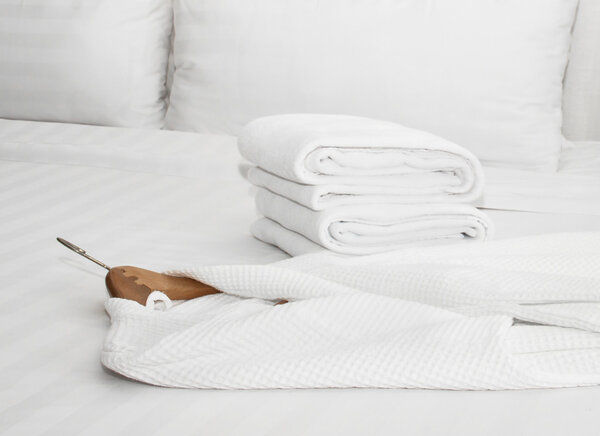 White bathrobe on the bed