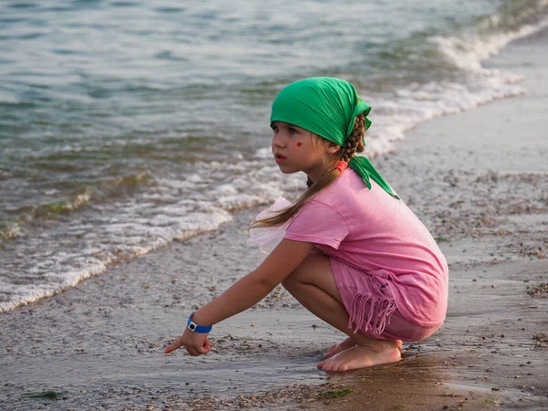 Yeşil Bandanalı Ukraynalı Kız Kumlu Bir Sahilde Deniz Kabuğu Topluyor — Stok fotoğraf